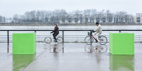 Woman riding bicycle on railing