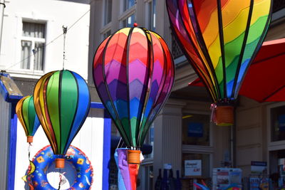 Close-up of colorful balloons hanging outside building