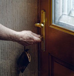 Close-up of hand holding closed door