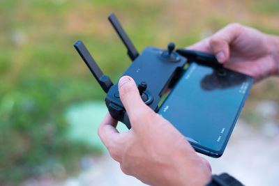 Close-up of person holding remote control