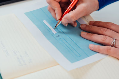 High angle view of person hand on table