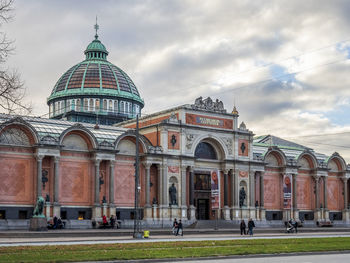 View of historic building against dramatic sky.