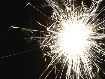 Low angle view of firework display at night