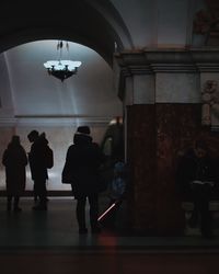 Silhouette people in corridor of building 