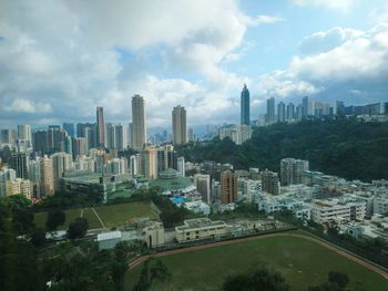 Aerial view of buildings in city against sky