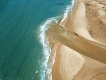 Top down drone view of beach and sea