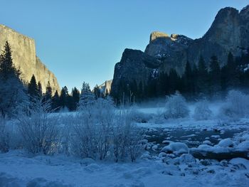 Scenic view of snow covered mountains against clear sky