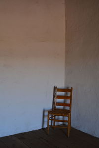 Chair on table against wall at home