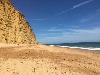 Scenic view of beach against blue sky