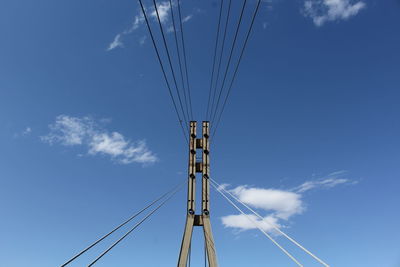 Low angle view of cables against blue sky