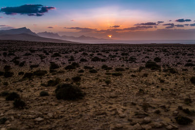 Scenic view of desert against sky during sunset