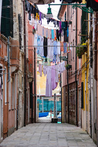 Clothes drying on street amidst buildings in city