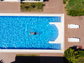 Man swimming in the pool top down view. person