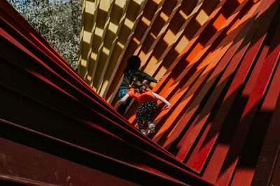 High angle view of people standing on staircase of building