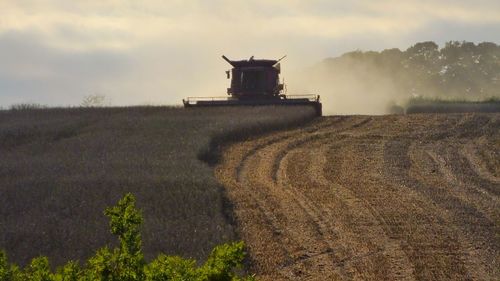 Scenic view of field against cloudy sky