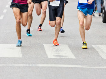 Low section of runners in marathon race on city street