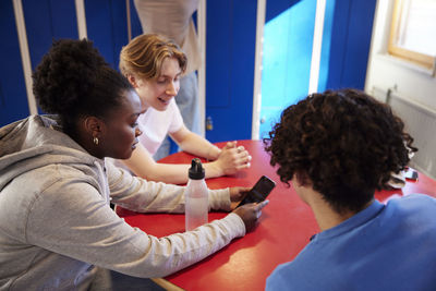 Teenagers talking in locker room