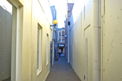 Empty alley amidst buildings in city