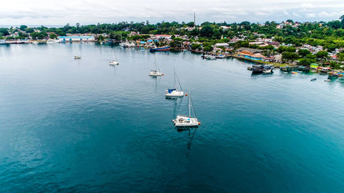 High angle view of sailboats moored on sea against sky