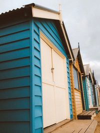 Huts at beach against sky