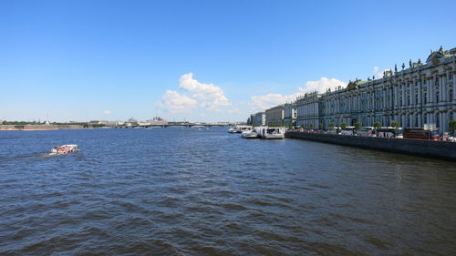 Boats in river with buildings in background