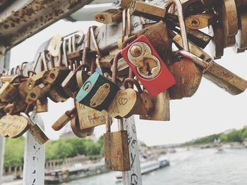 Close-up of padlocks hanging on rusty metal