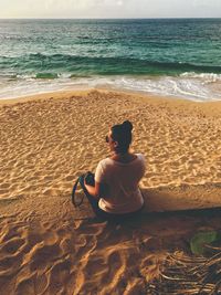 Boy sitting on beach