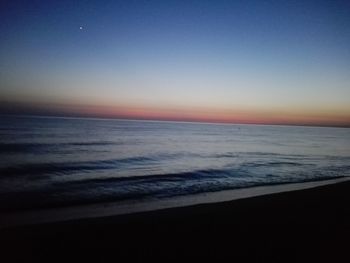 Scenic view of sea against clear sky during sunset