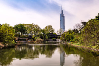 Reflection of trees and buildings in lake