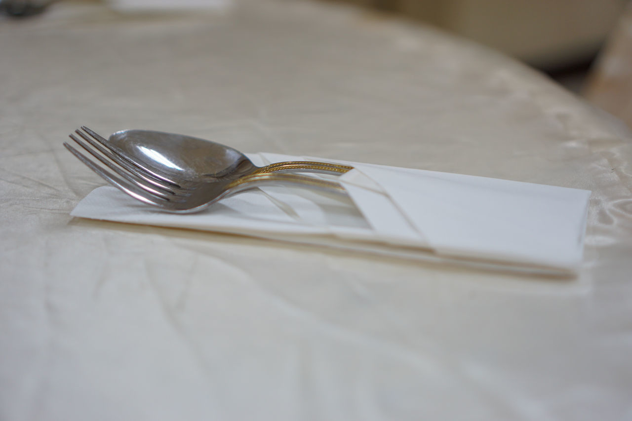 CLOSE-UP OF FORK AND SPOON ON TABLE