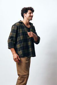 Young man standing against white background