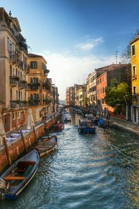 Boats in canal with buildings in background