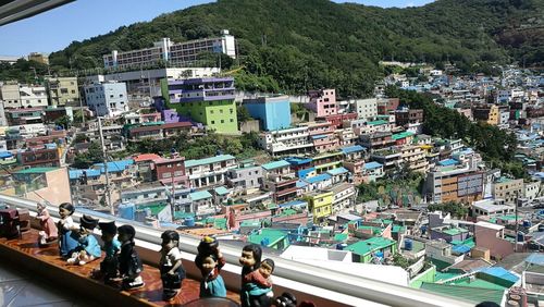 High angle view of people on swimming pool against buildings in city