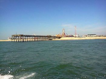 Pier in sea against clear sky