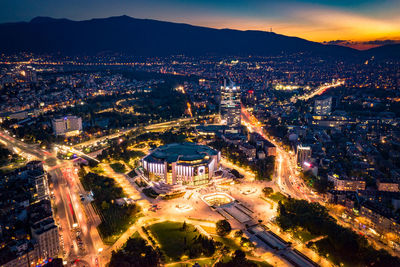 High angle view of illuminated city buildings at night