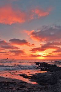 Scenic view of beach against sky during sunset