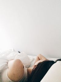 Low section of woman sleeping on bed