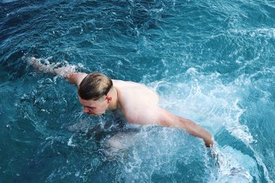 High angle view of man swimming in sea