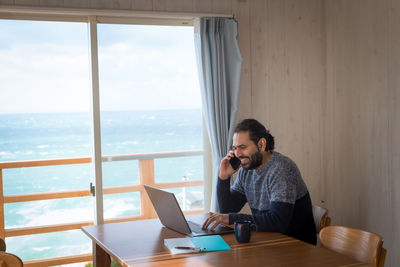 Man sitting on table at home