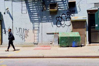 Full length of woman standing by railing