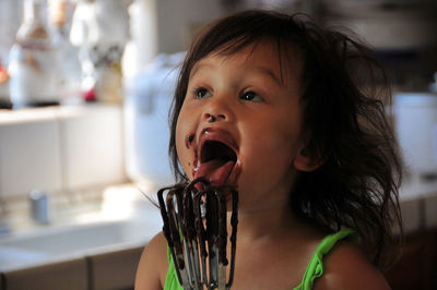 Close-up portrait of cute girl at home