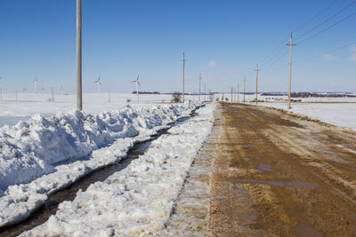 Snow covered road against sky