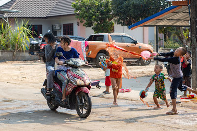 People riding motorcycle on road