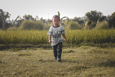 Young man standing on field