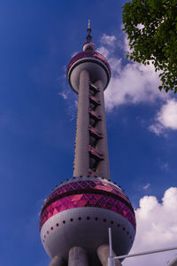 Low angle view of building against cloudy sky