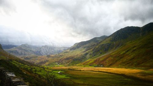 Scenic view of mountains against cloudy sky