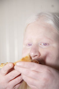 Close-up portrait of cute baby eating food