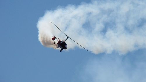 Low angle view of helicopter against sky