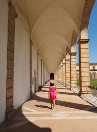 Rear view of woman on colonnade
