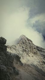 Scenic view of mountains against cloudy sky